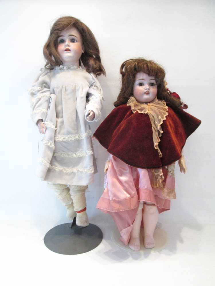 Appraisal: TWO GERMAN BISQUE HEAD DOLLS one with brown wig blue