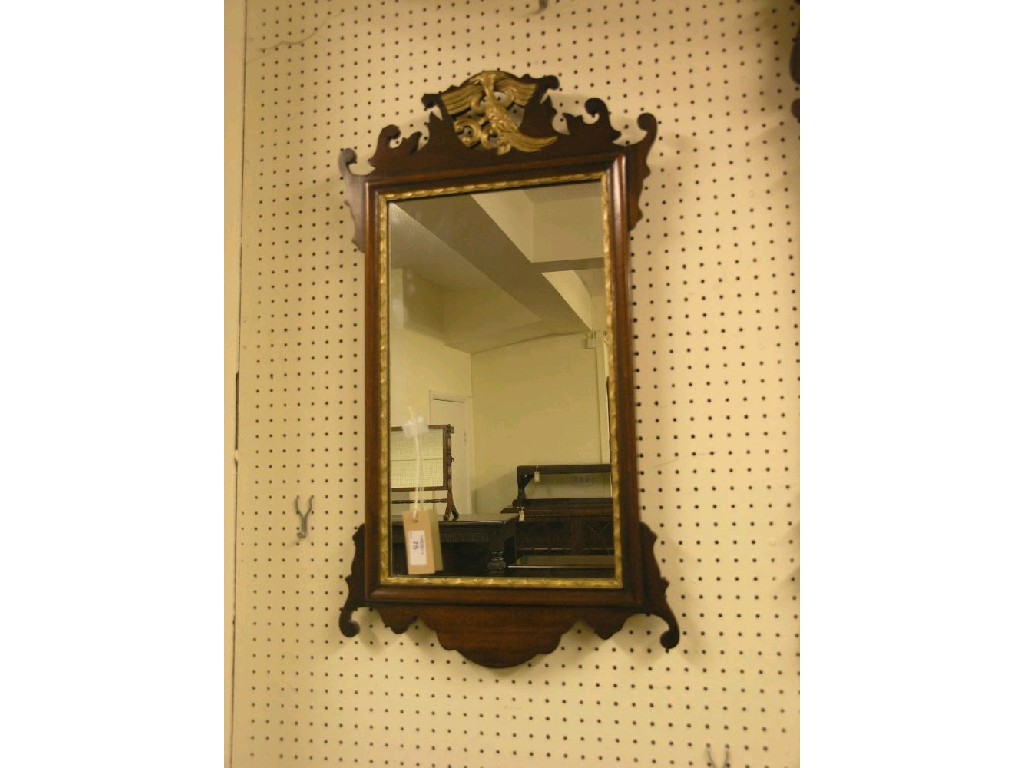 Appraisal: A Chippendale-style mahogany and parcel-gilt mirror fret-carved cresting with gilt