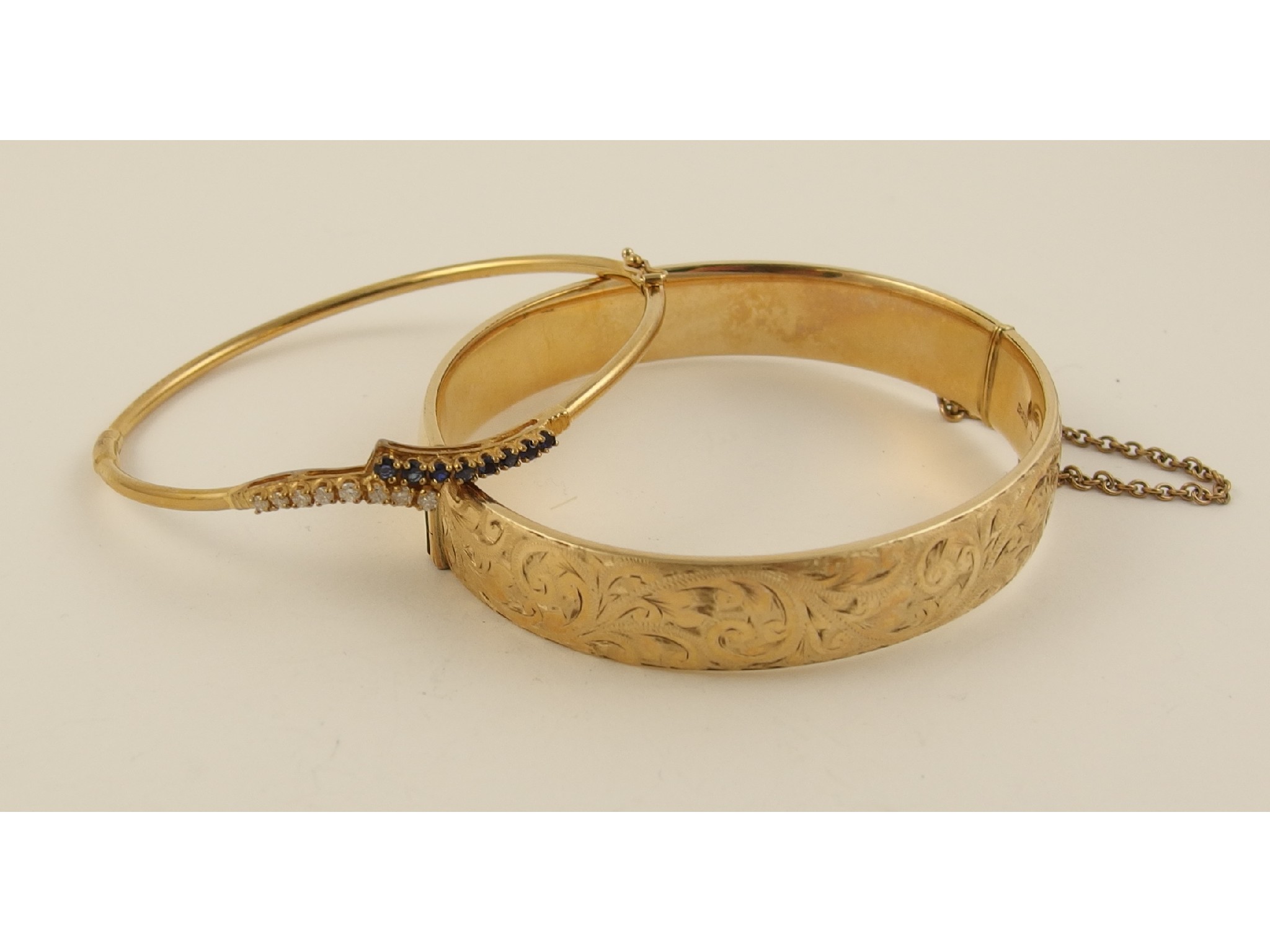 Appraisal: A ct metal core engraved bangle together with a ct