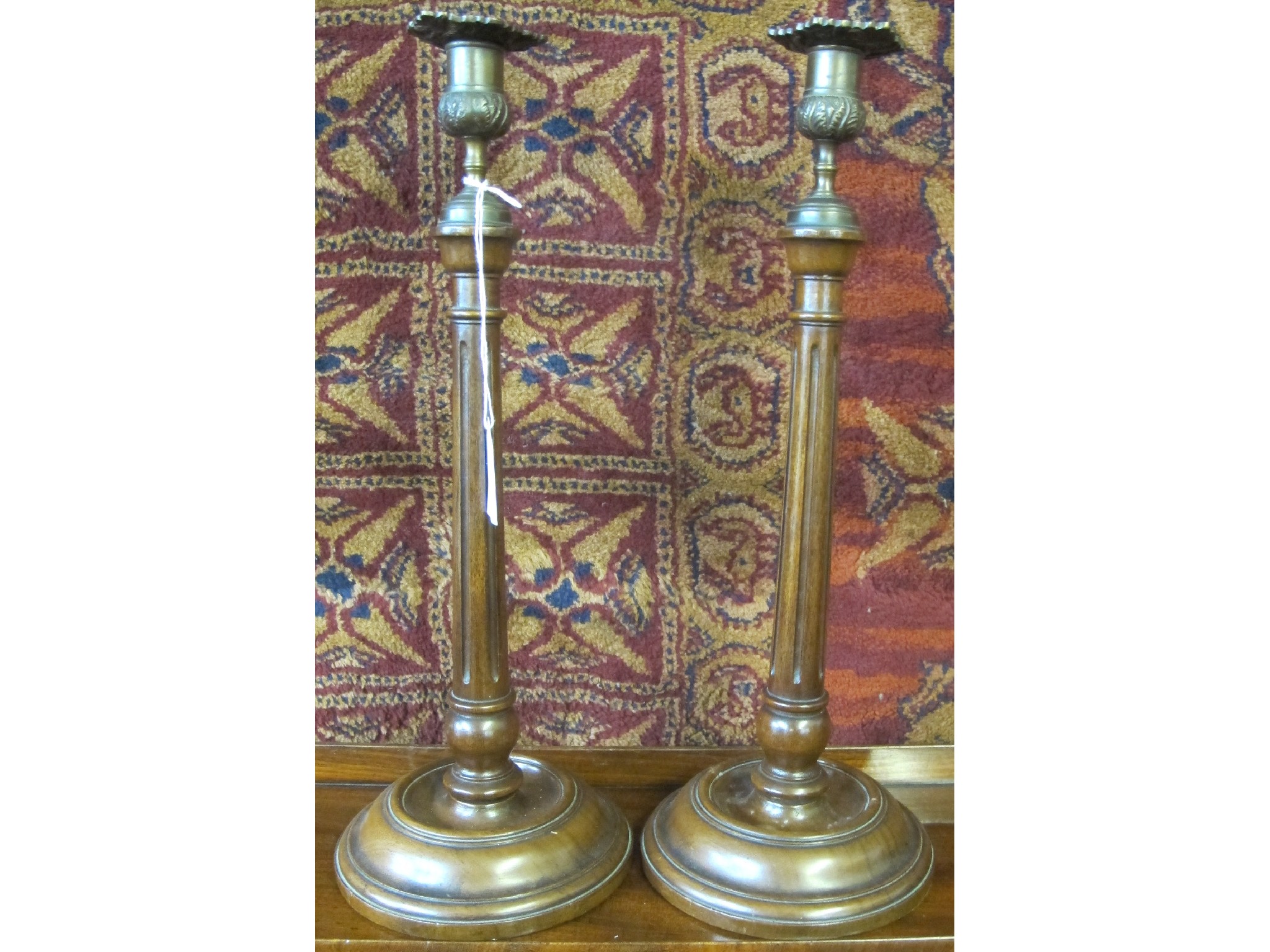 Appraisal: A pair of mahogany candlesticks