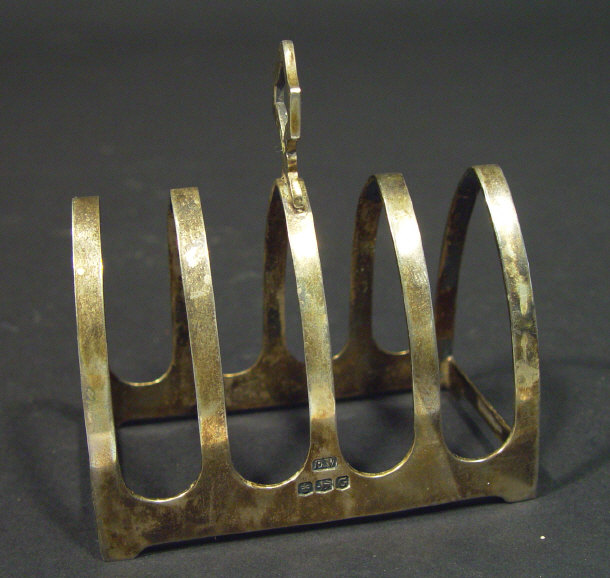 Appraisal: Silver four slice Gothic arch toast rack Sheffield cm high