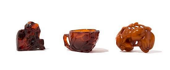 Appraisal: Three Carved Amber Articles Width of widest inches Three Carved