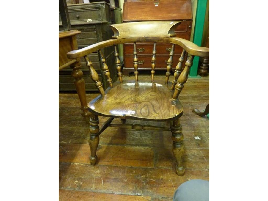 Appraisal: A th century elm and beechwood smokers bow elbow chair