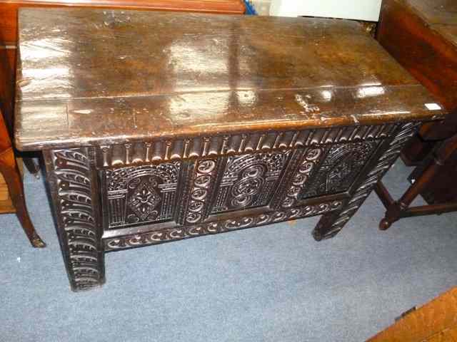 Appraisal: A SMALL ANTIQUE OAK COFFER with chip carved triple panelled