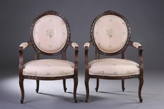 Appraisal: PAIR LOUIS XVI STYLE FAUTEUILS late th century Floral-crested medallion