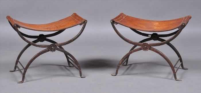 Appraisal: PAIR OF ITALIAN RENAISSANCE-STYLE WROUGHT IRON FOLDING STOOLS WITH LEATHER