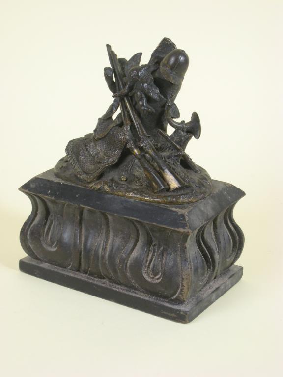 Appraisal: A bronzed metal Seal Holder with jockey type cap amongst