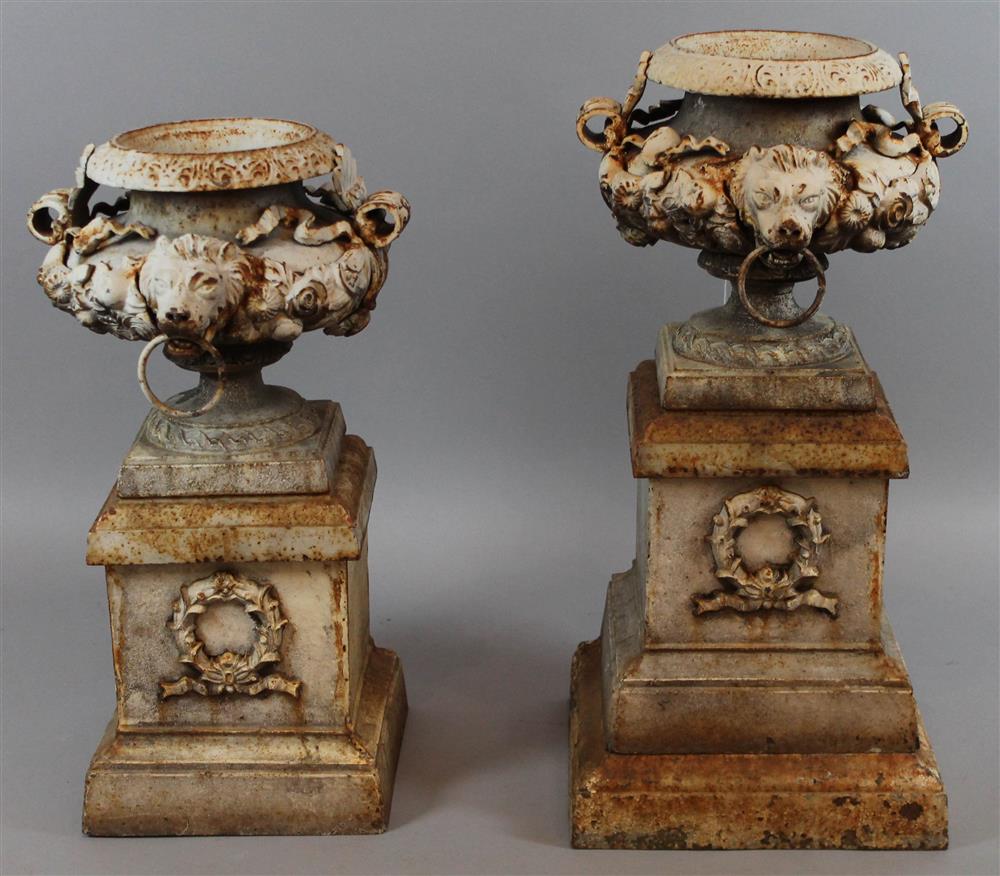 Appraisal: PAIR OF WHITE PAINTED CAST IRON URNS having a stamped