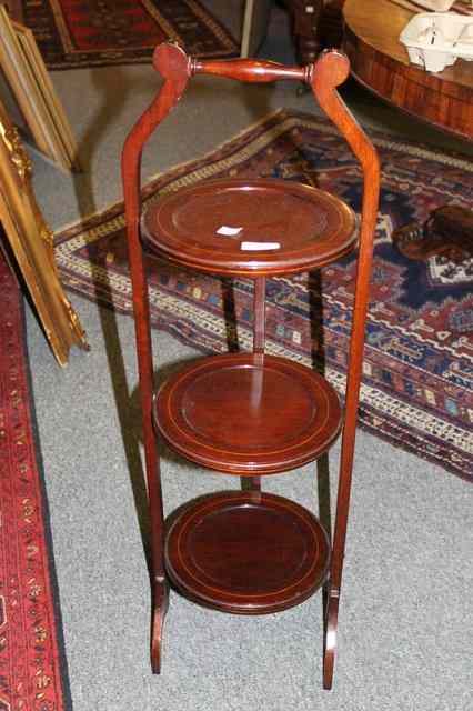 Appraisal: AN EDWARDIAN MAHOGANY THREE TIER CAKE STAND