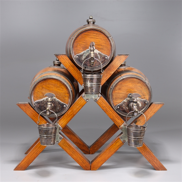 Appraisal: Decanter set of three English wood whiskey barrels each mounted