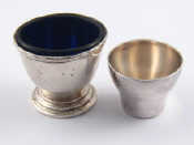 Appraisal: A silver egg cup with blue glass liner hallmarked Birmingham