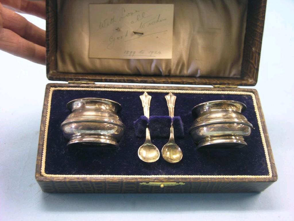 Appraisal: A cased pair of silver salts complete with server spoon