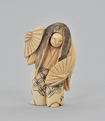 Appraisal: A Carved Ivory Netsuke Carved standing figure in robes with