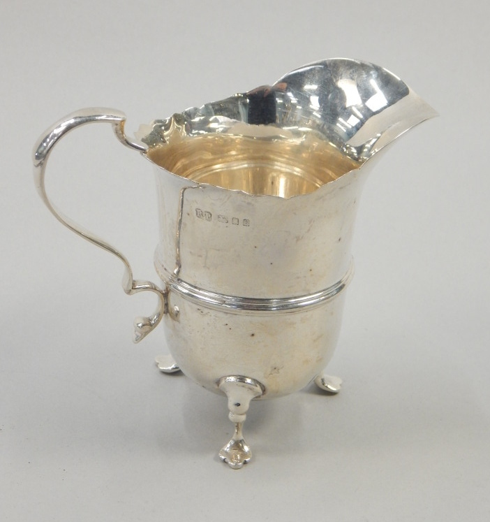 Appraisal: An Edwardian silver helmet shaped coal scuttle on three feet