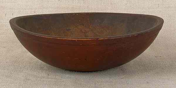 Appraisal: Turned bowl th c retaining an old red stained surface