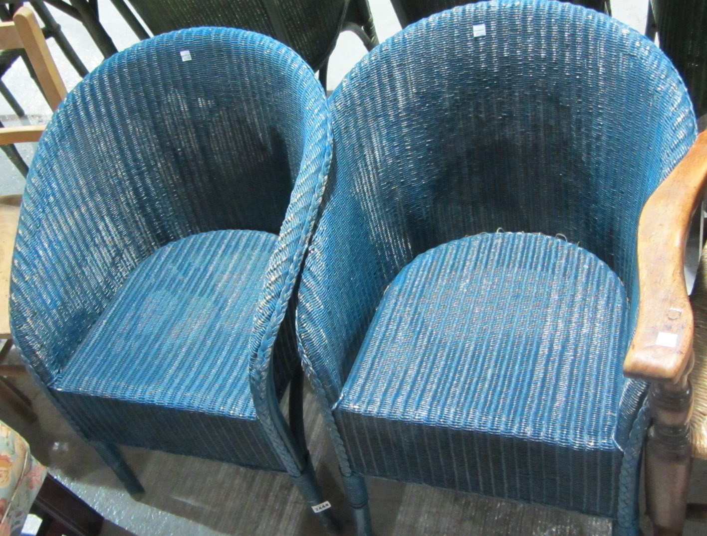 Appraisal: A pair of Lloyd Loom style blue tub back chairs