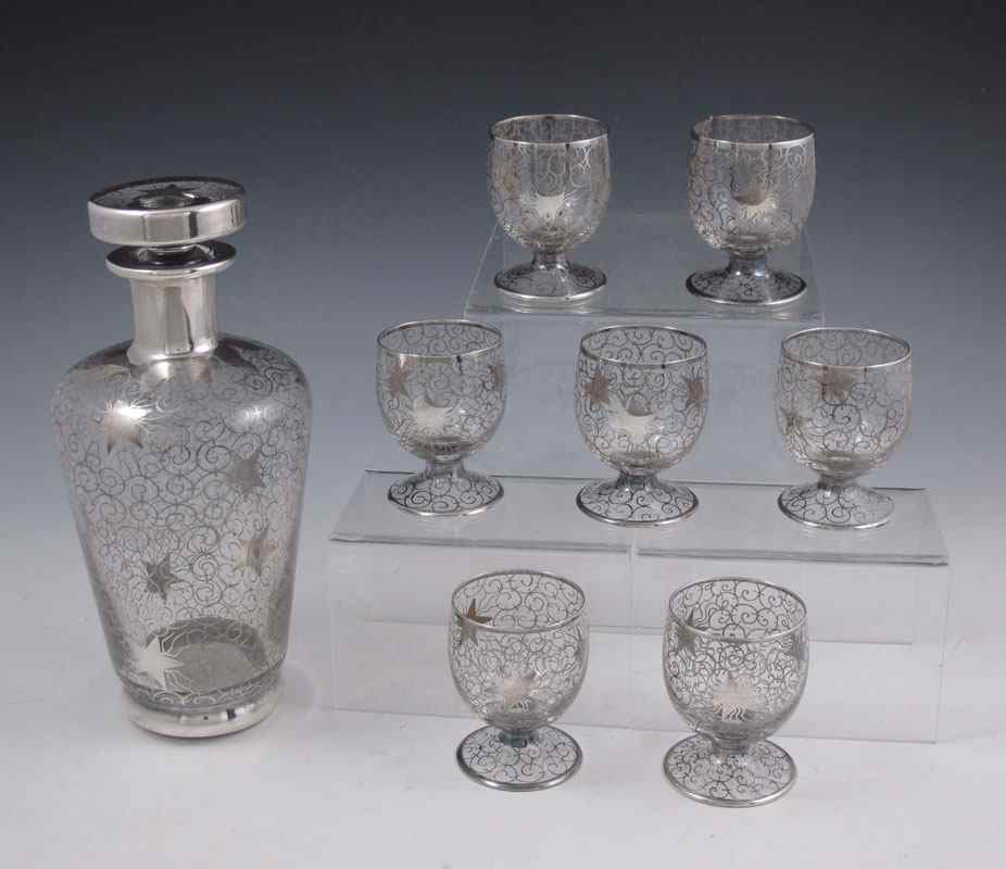 Appraisal: SILVER OVERLAY LIQUOR SET Illegibly signed decanter with etched number