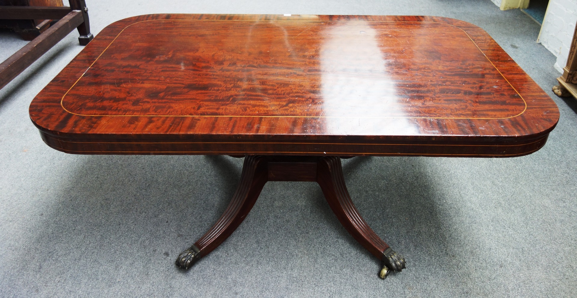 Appraisal: A Regency inlaid mahogany snap-top breakfast table the rounded rectangular