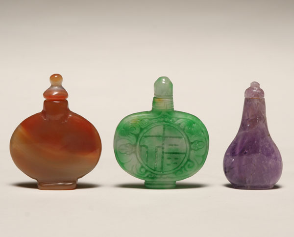 Appraisal: Three Chinese snuff bottles including a green jade flattened form