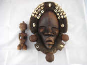 Appraisal: An African mask with cowrie shells and a wooden African