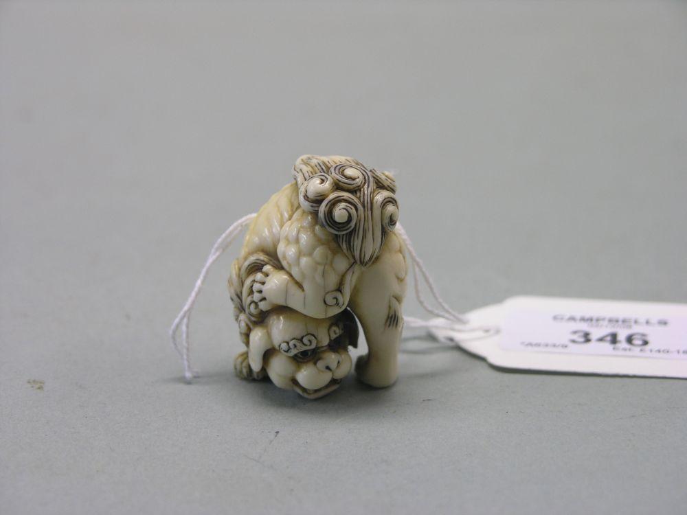 Appraisal: A Japanese ivory netsuke Meiji period a shi-shi signed in