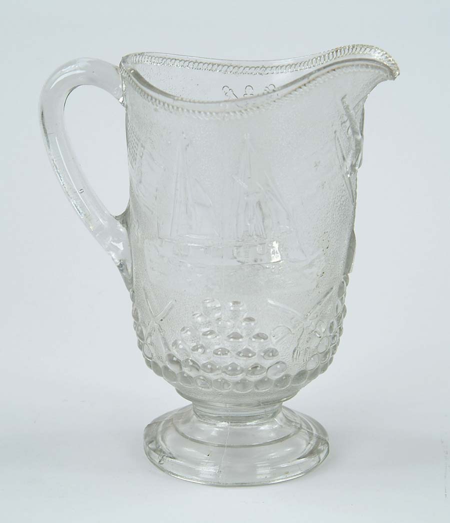 Appraisal: ADMIRAL DEWEY WATER PITCHER Clear glass pitcherdepicts Admiral Dewey surrounded