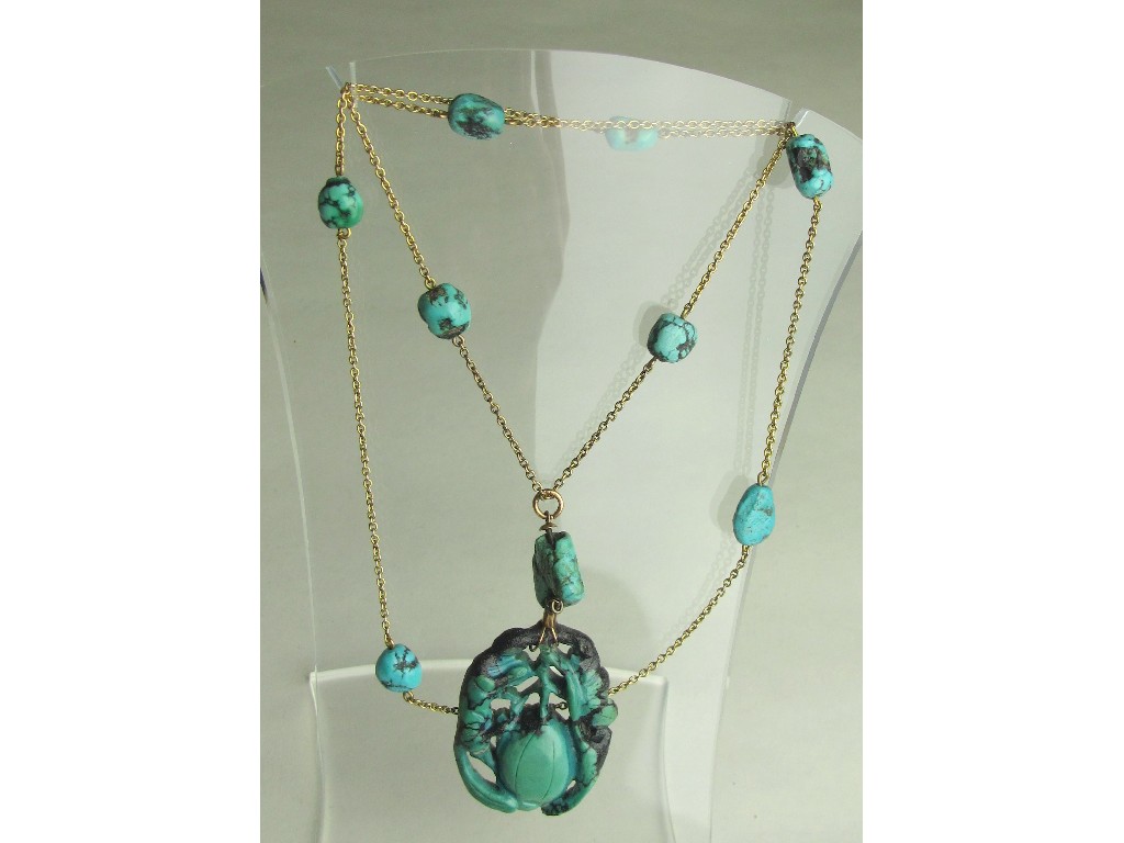 Appraisal: Carved turquoise pendant on rose gold neckchain with turquoise bead