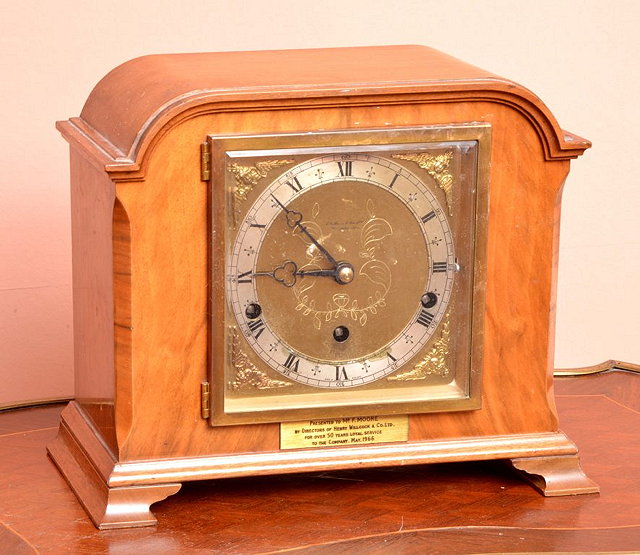 Appraisal: A WALNUT CASED MANTEL CLOCK with Westminster chime retailed by