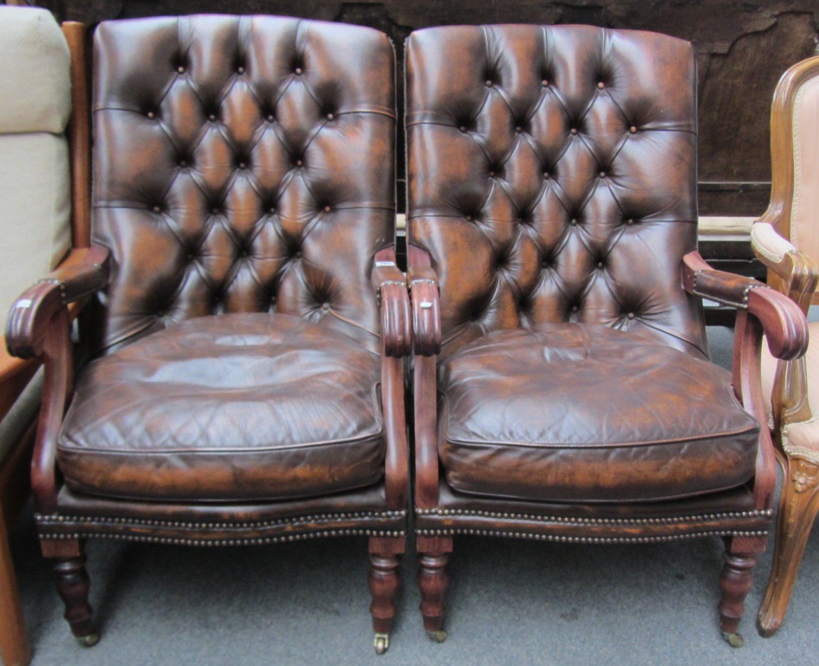 Appraisal: A pair of Regency style leather upholstered hardwood framed open