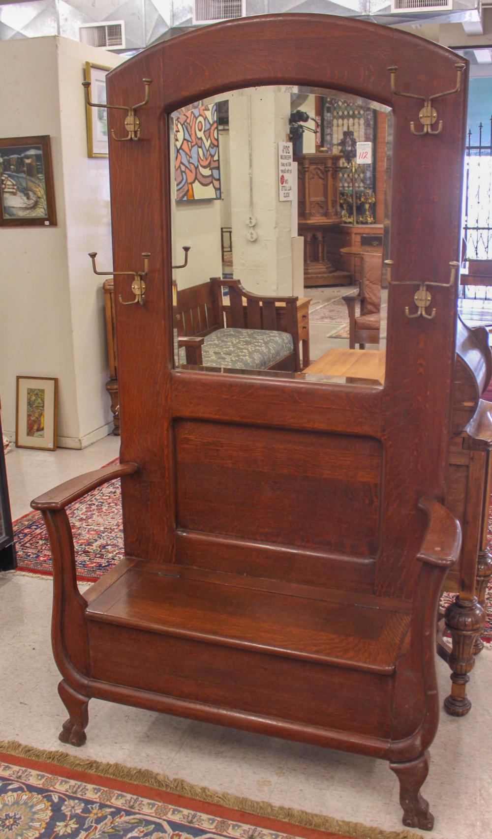 Appraisal: AN OAK SETTLE-BASE HALLSTAND American c with storage under the