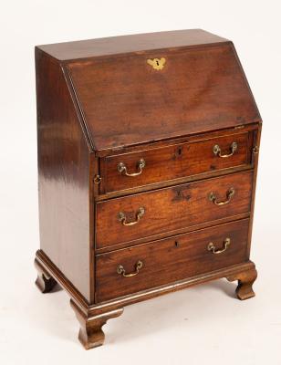 Appraisal: A George III mahogany bureau the fall-flap enclosing a simple