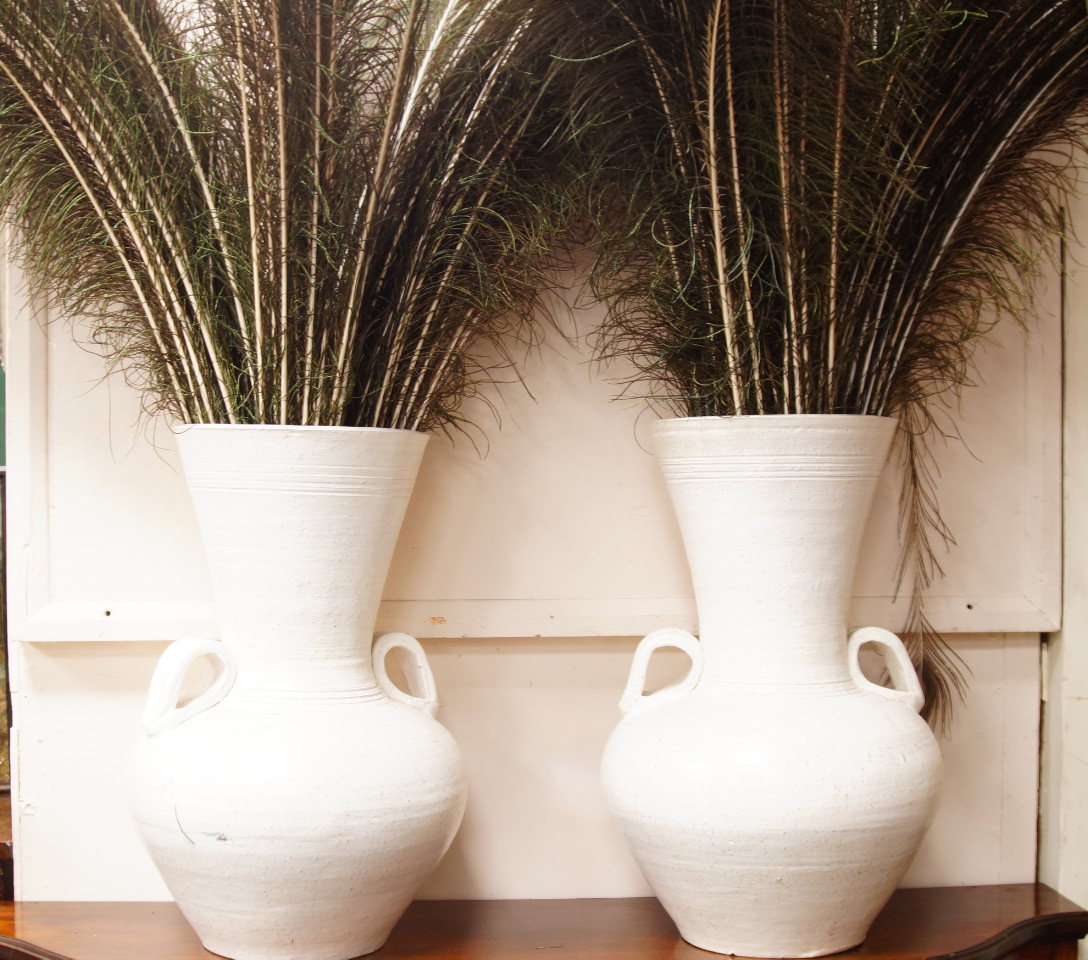 Appraisal: A pair of white glazed twin handled pottery vases containing