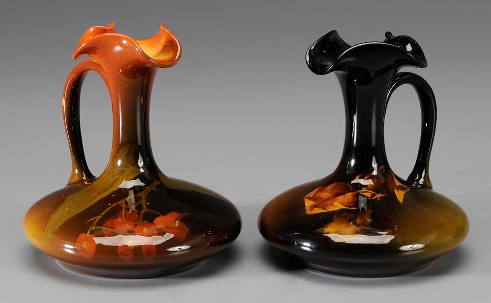 Appraisal: Pair Rookwood Ewers one with autumn leaves on varying black