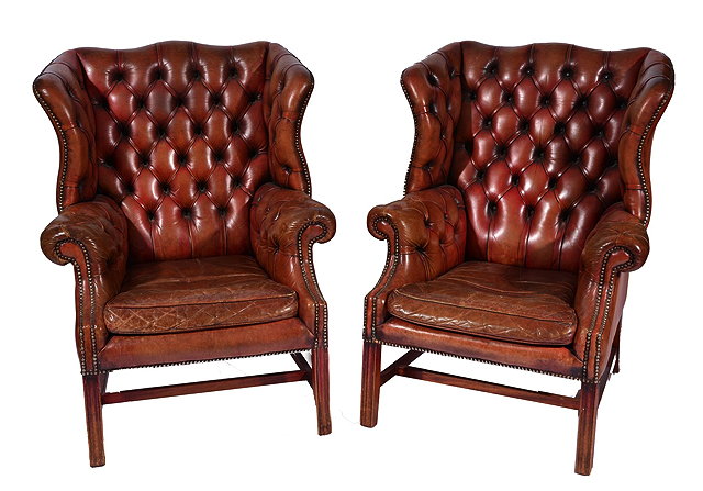 Appraisal: A PAIR OF TH CENTURY STYLE WING BACK CLUB ARMCHAIRS