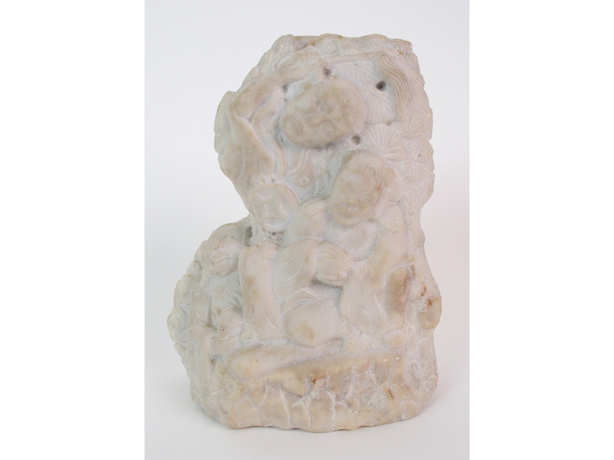 Appraisal: A Chinese marble boulder carvingdepicting three figures seated beneath a