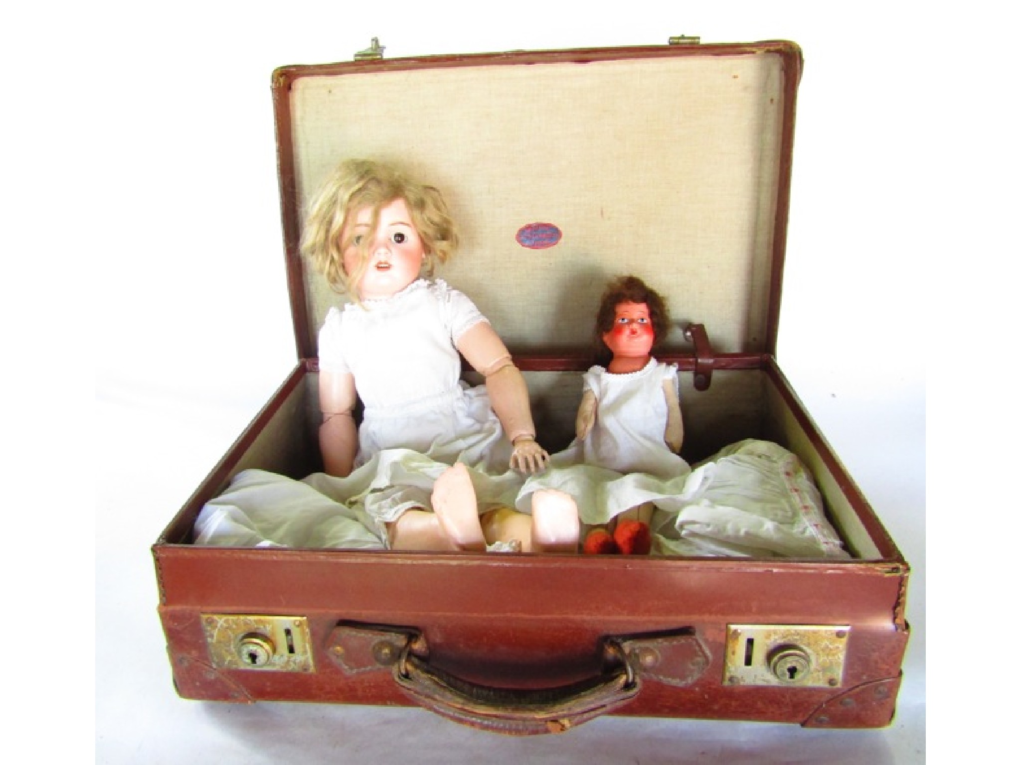 Appraisal: A th century stitched suitcase containing a bisque headed doll