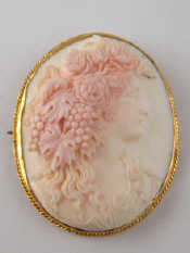 Appraisal: A carved coral cameo of a lady in a yellow