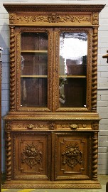 Appraisal: A Victorian elevated bookcase in oak profusely carved with foliate