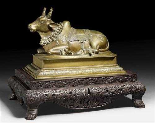 Appraisal: RECLINING NANDI India th century L cm Bronze With carved