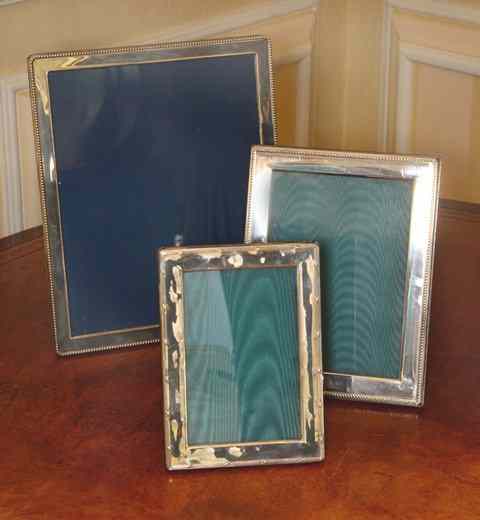 Appraisal: THREE SILVER PHOTO FRAMES the largest x