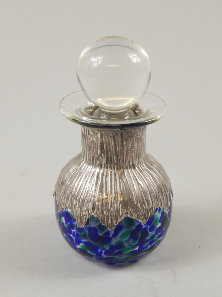 Appraisal: A mottled glass and silver scent bottle the mount with