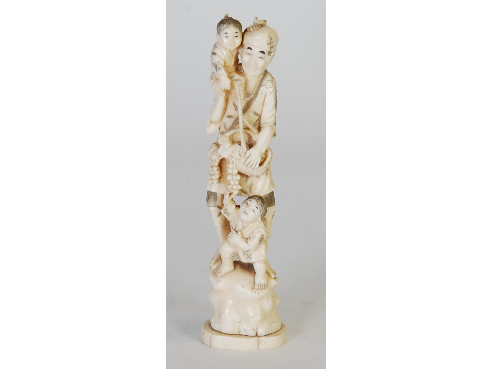 Appraisal: AN ORIENTAL CARVED ON PIECE MARINE IVORY GROUP OF A