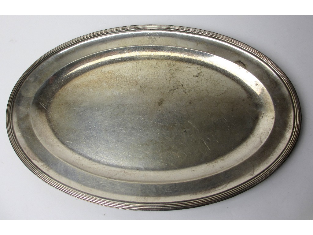 Appraisal: An oval silver platter of classic shallow form with ribbed