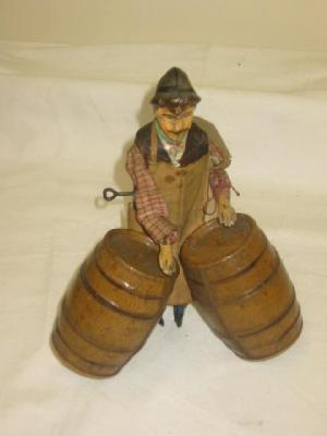 Appraisal: A French early tin plate novelty toy a drayman rolling