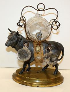 Appraisal: French bull tantalus set with mini glass keg glasses French