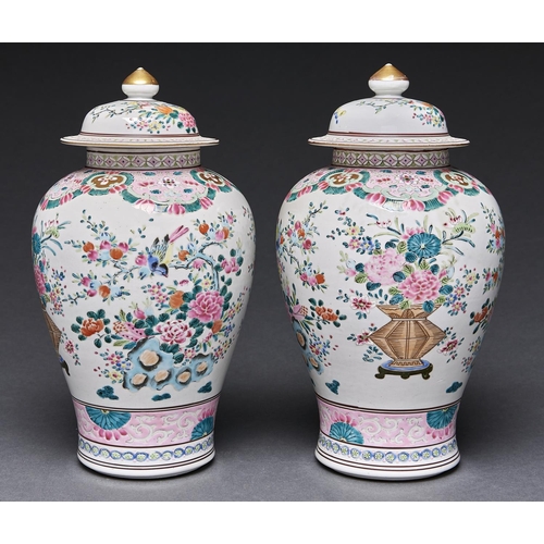 Appraisal: A pair of Chinese famille rose vases and covers decorated