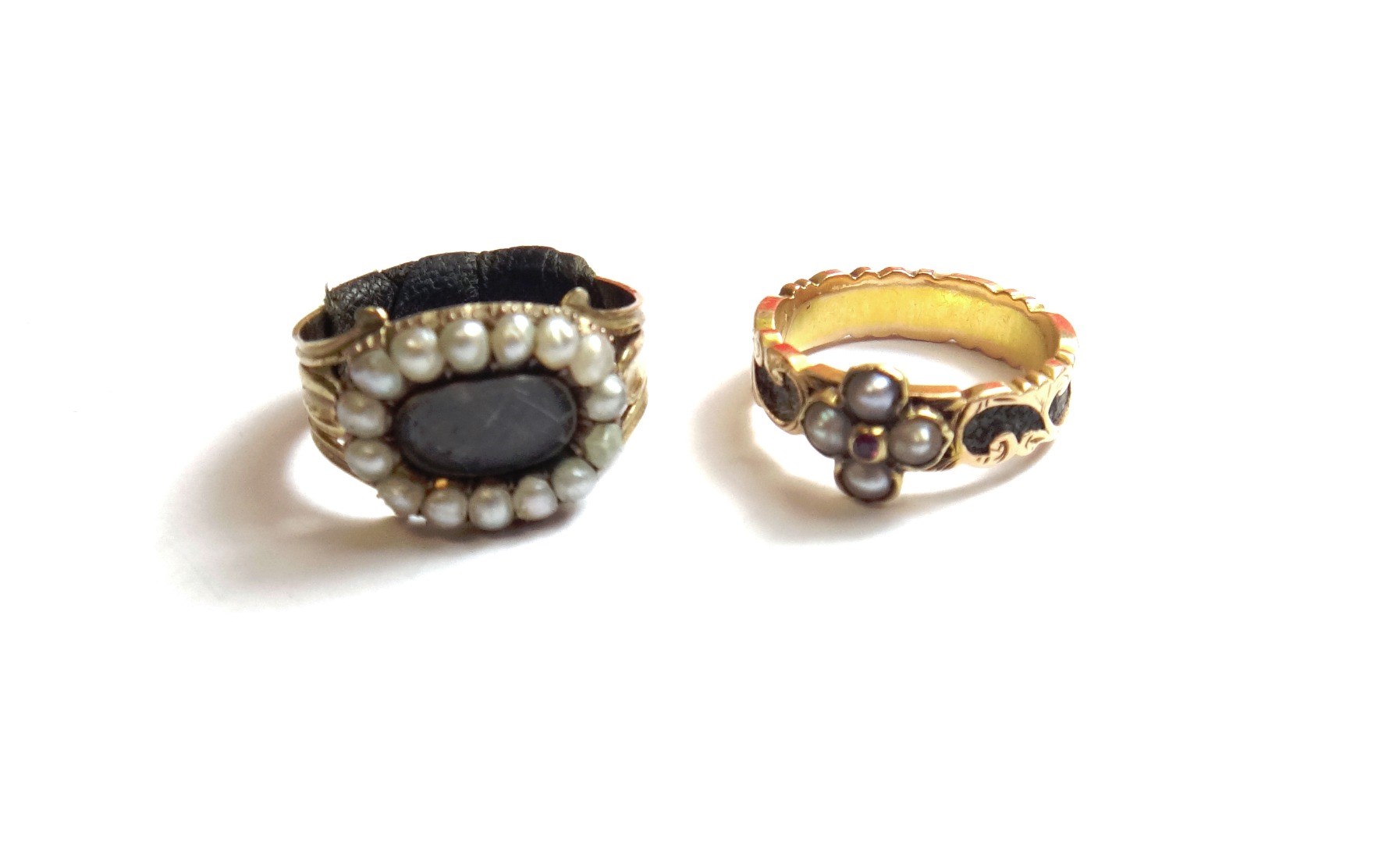 Appraisal: A Victorian gold half pearl and ruby set mourning ring