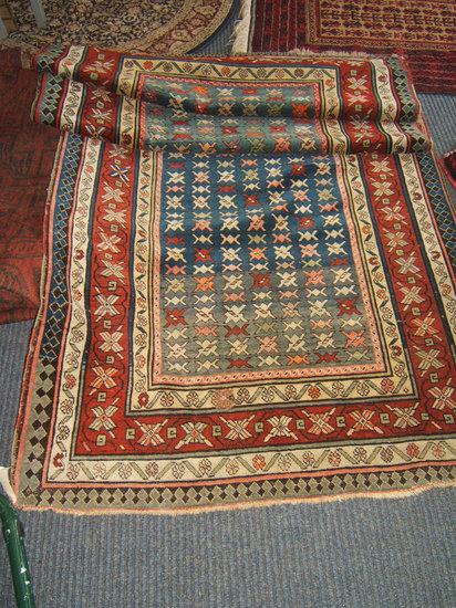 Appraisal: A Middle Eastern runner with multiple banded border geometric designs