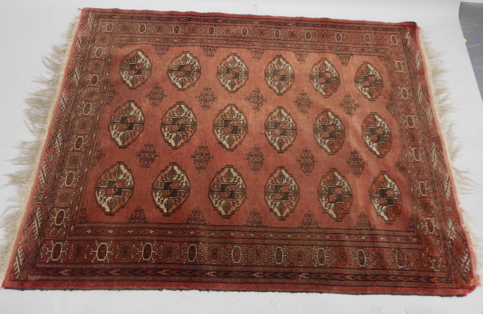 Appraisal: An Afghan style rug with a medallion design predominately in