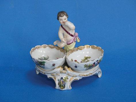 Appraisal: A BERLIN PORCELAIN TABLE SALT modelled as a cherub by